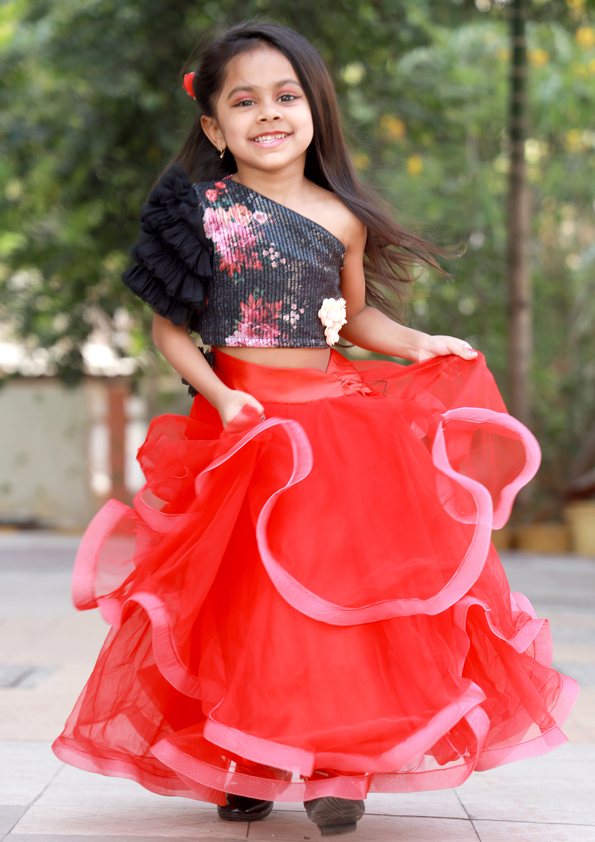 Young girl in a black floral top and red ruffled skirt - Fashion Designer in Pune