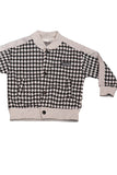 Children's outfit with houndstooth jacket and gray pants on a white background - Fashion Designer in Pune