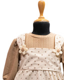 Children's dress with floral details on a mannequin against a white background - aura fashionista