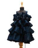 Navy blue ruffled dress on a mannequin against a white background by fashion designers in pune