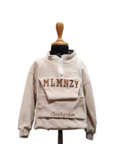 Beige fleece pullover with 'MLMNZY' branding on a mannequin against a white background by fashion designers in pune