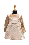 Children's dress with brown sleeves and beige apron on a mannequin against a white background - best fashion designers in pune