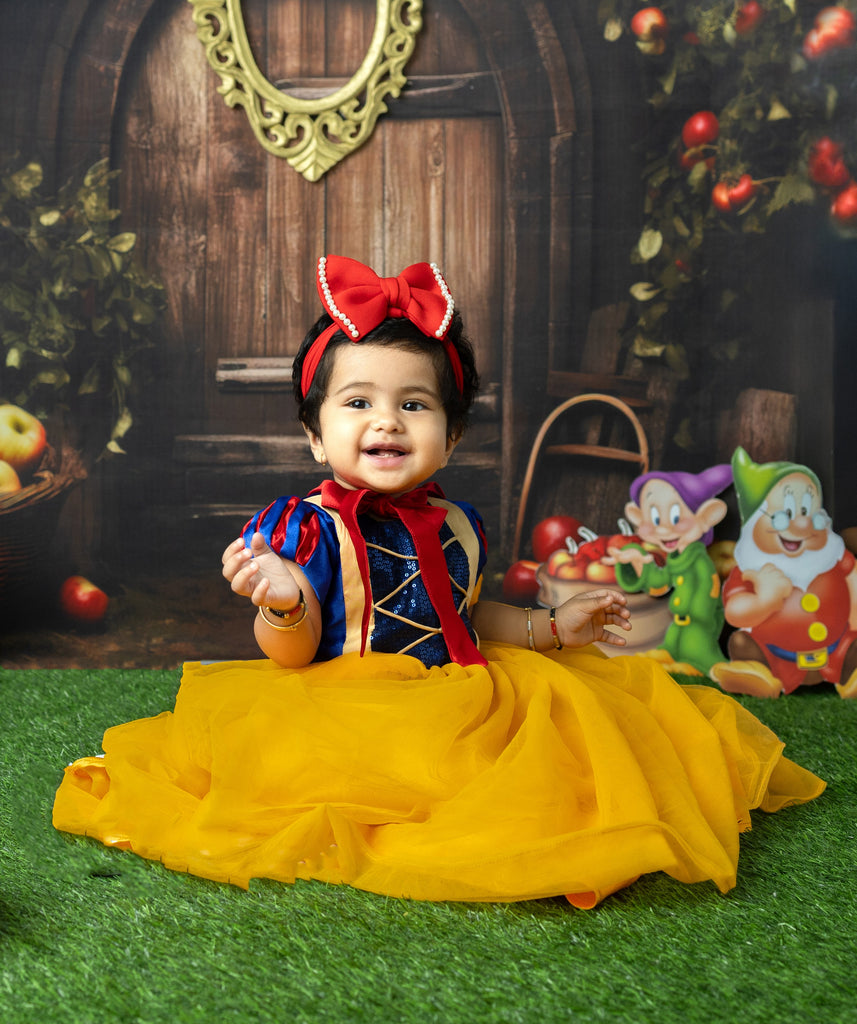 Child in Snow White costume with animated characters in a fantasy setting