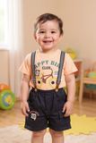Child wearing a 'Happy Bike Club' t-shirt and suspenders in a room with toys - Fashion designer in pune