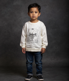 Child wearing a white sweatshirt with text and blue jeans on a dark background by fashion designers in pune
